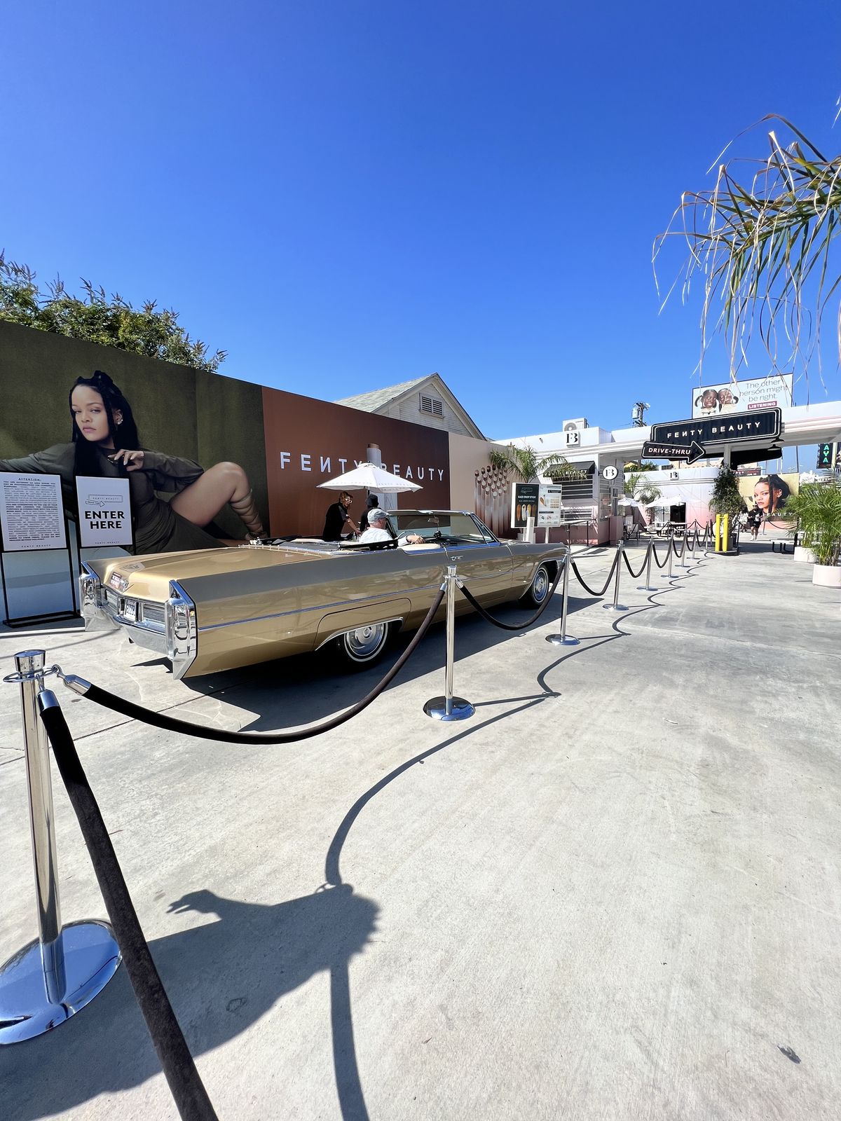Branded drive-thru activation with a vintage gold convertible